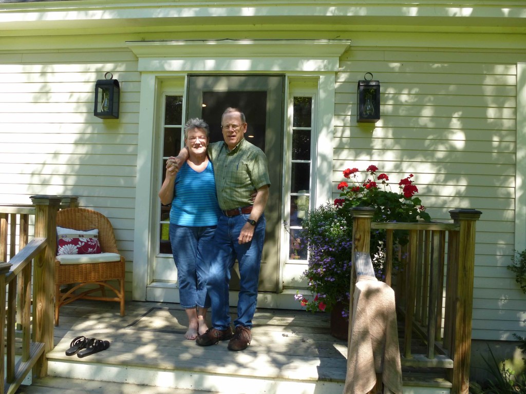 Photo of Dale and Russ standing on the front steps of a house.