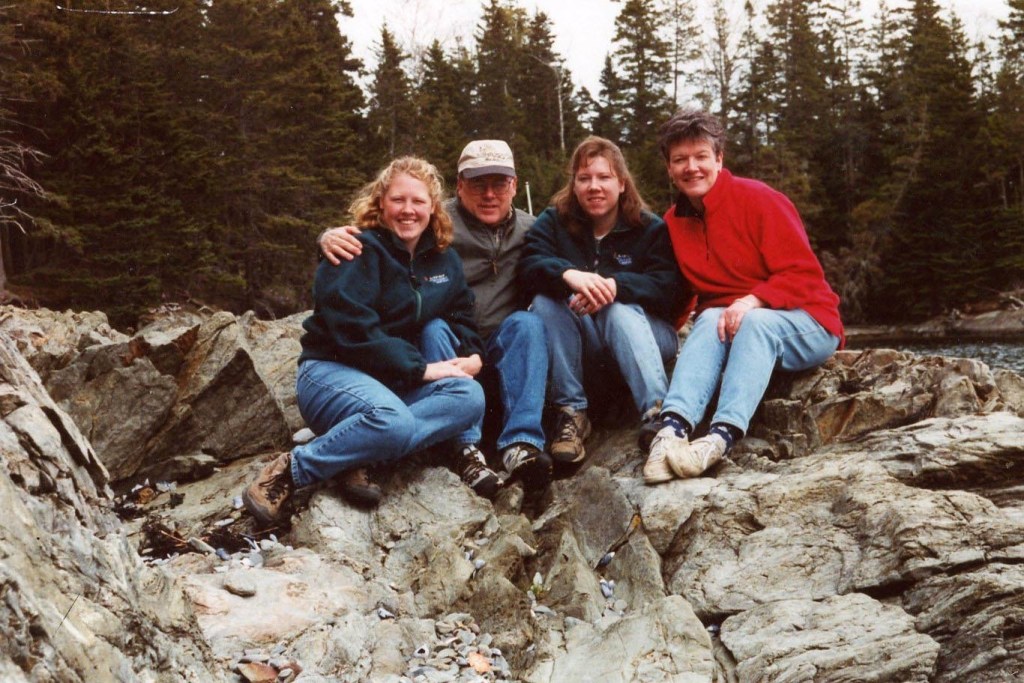 Our family of four sitting on the rocks on the Maine coast.